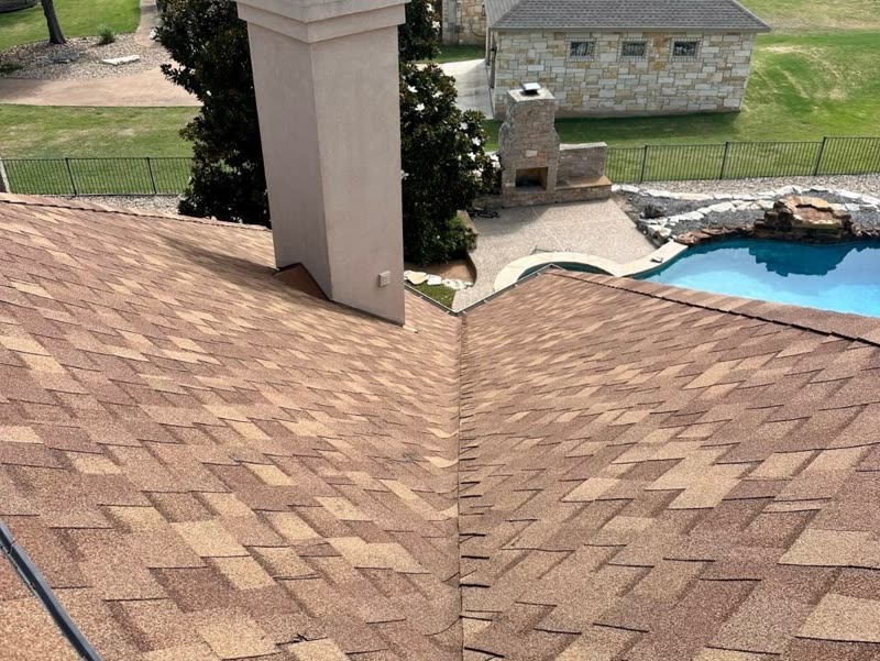 New architectural shingle roof on a hilltop home overlooking a pool and open Hill Country.